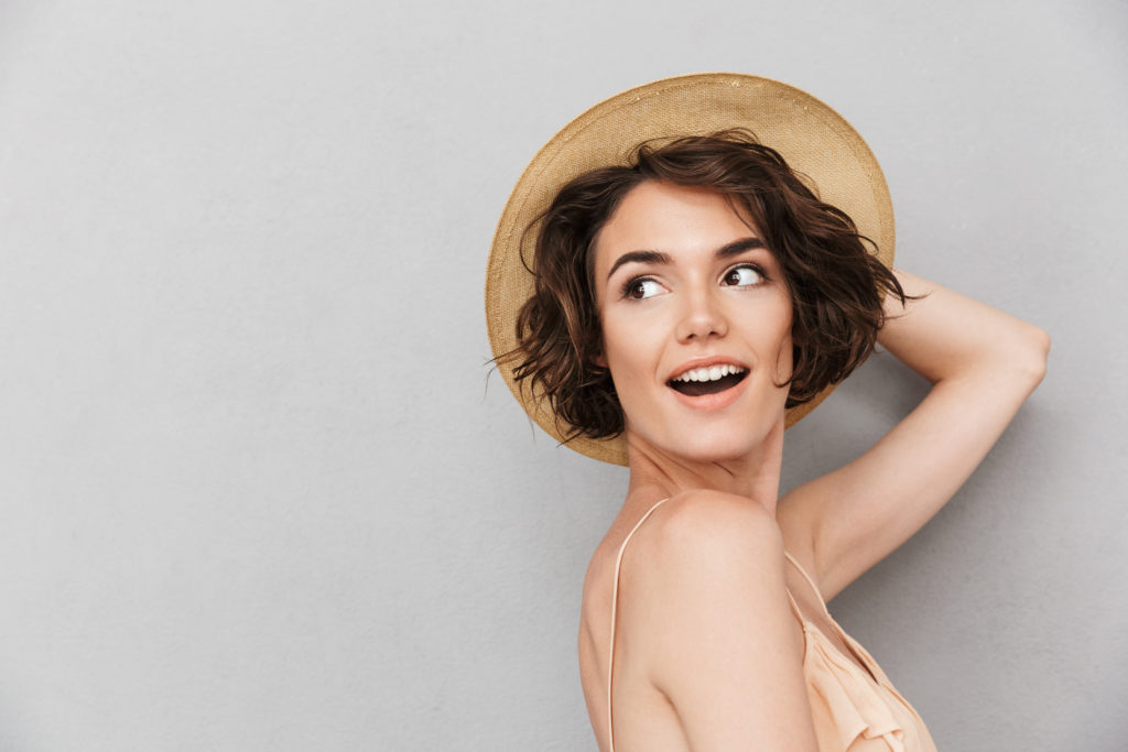 Smart Smiling Woman Posing in Dessert by Wearing cap | Aviva Medical in Centennial, CO