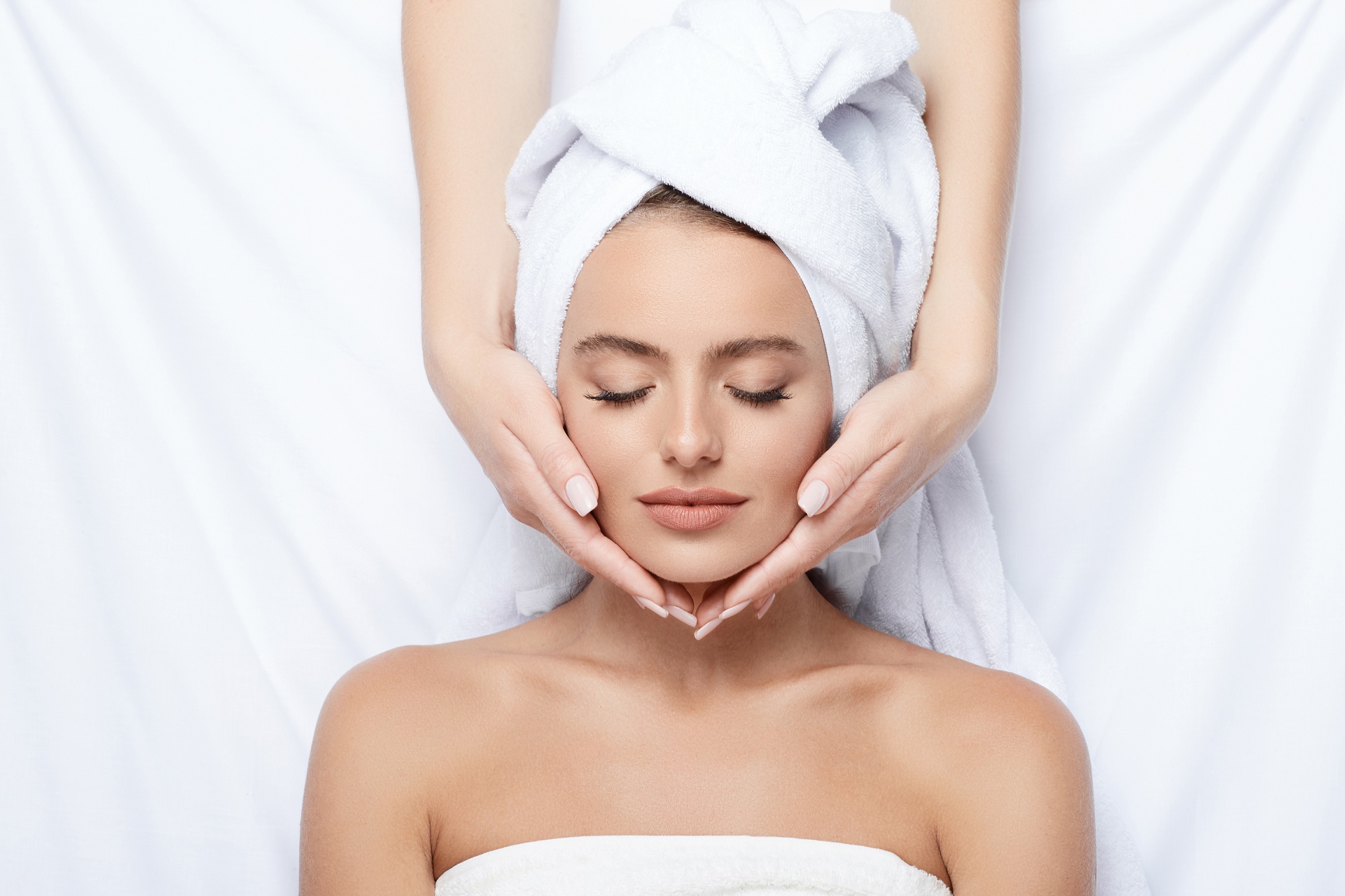 Young Closed Eyes Woman Lying on Bed and Undergoing Chemical Peels Treatment | Aviva Medical in Centennial, CO.