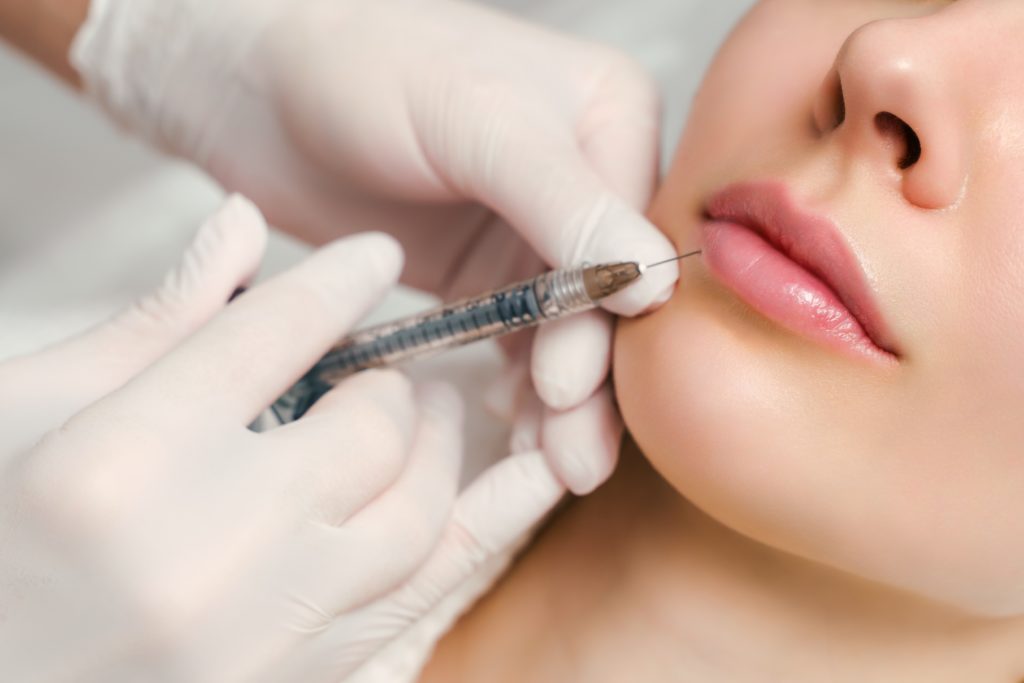 Woman's Face Taking Aesthetic Injection | Aviva Medical in Centennial, CO